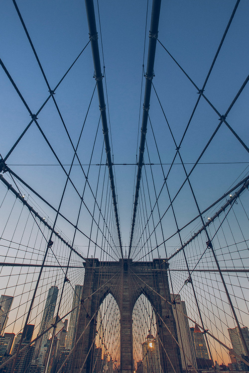 Photo of the Brooklyn Bridge as shot from the bridge moving toward New York City looking up at the trusses shot by Garth Pratt.